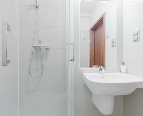 kleines helles Badezimmer mit Spiegel und Dusche