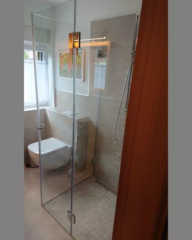 Dusche mit Falttüren F1W aus Glas bodengleich mit grauen Mosaikfliesen